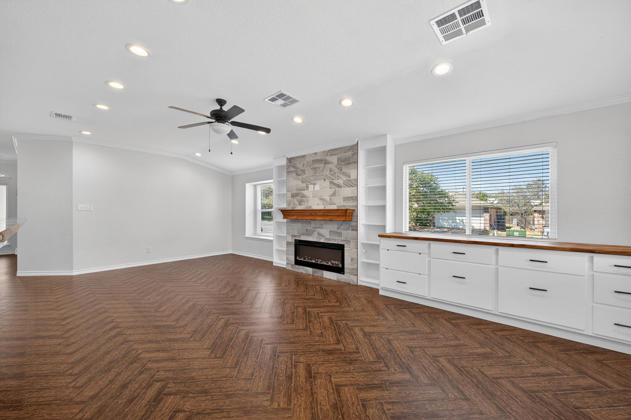 1201 Dillon Lake Bend Leander, TX 78641 - Photo 8 of 38 Living room with a stone fireplace, recessed lighting, healthy amount of natural light, a ceiling fan, and ornamental molding