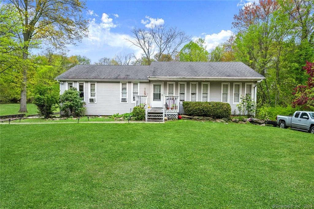 2105 Reservoir Avenue Trumbull, CT 06611 - Photo 1 of 1 a front view of a house with a garden