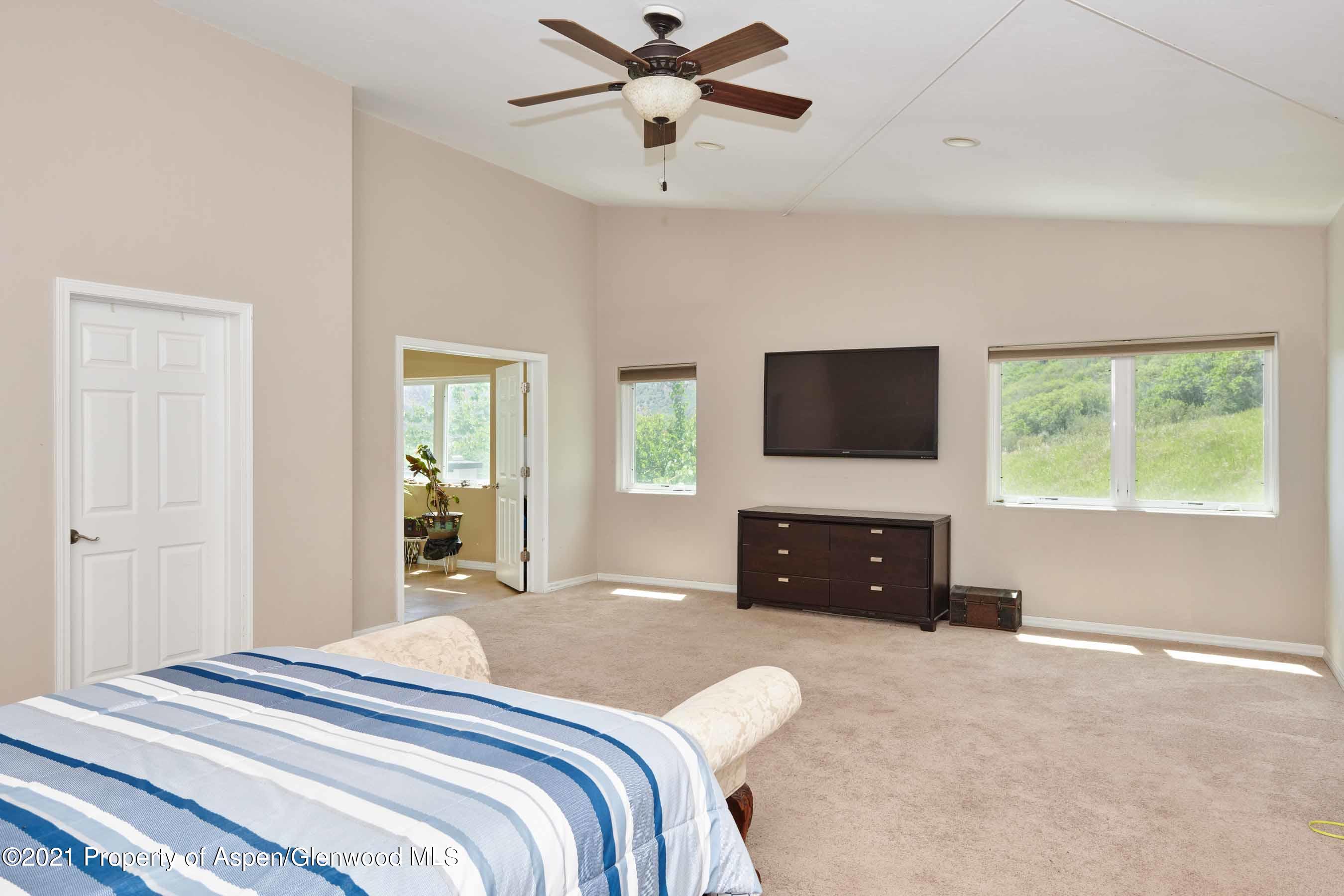 403 Lester Lane Basalt, CO 81621 - Photo 13 of 31 a bedroom with a bed and a flat screen tv