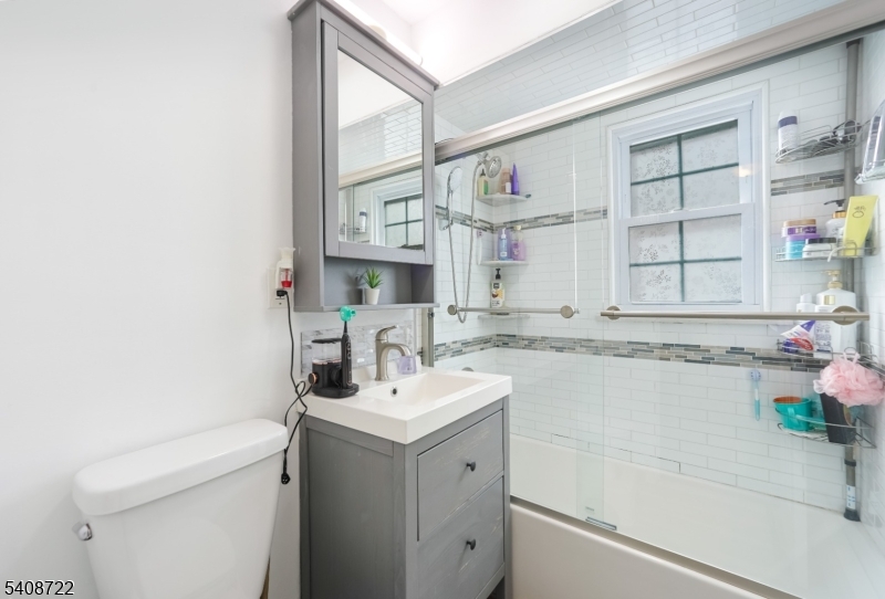 119 East 13th Street Linden, NJ 07036 - Photo 4 of 22 a bathroom with a sink a vanity and a bathtub