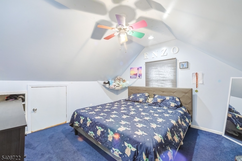 119 East 13th Street Linden, NJ 07036 - Photo 7 of 22 a bedroom with a bed and a chandelier