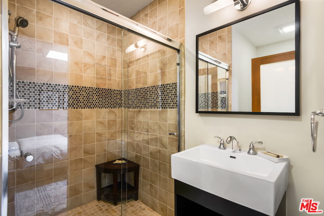 14673 Deervale Place Sherman Oaks, CA 91403 - Photo 14 of 25 a bathroom with a sink a toilet and mirror