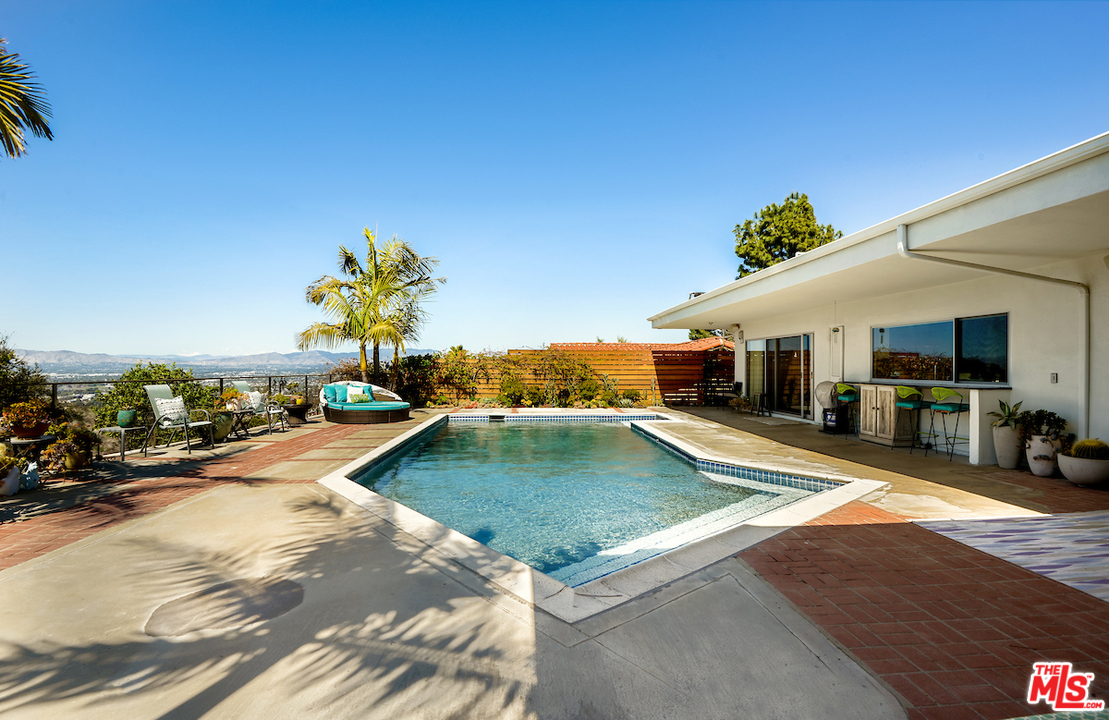 14673 Deervale Place Sherman Oaks, CA 91403 - Photo 24 of 25 a view of a house with swimming pool