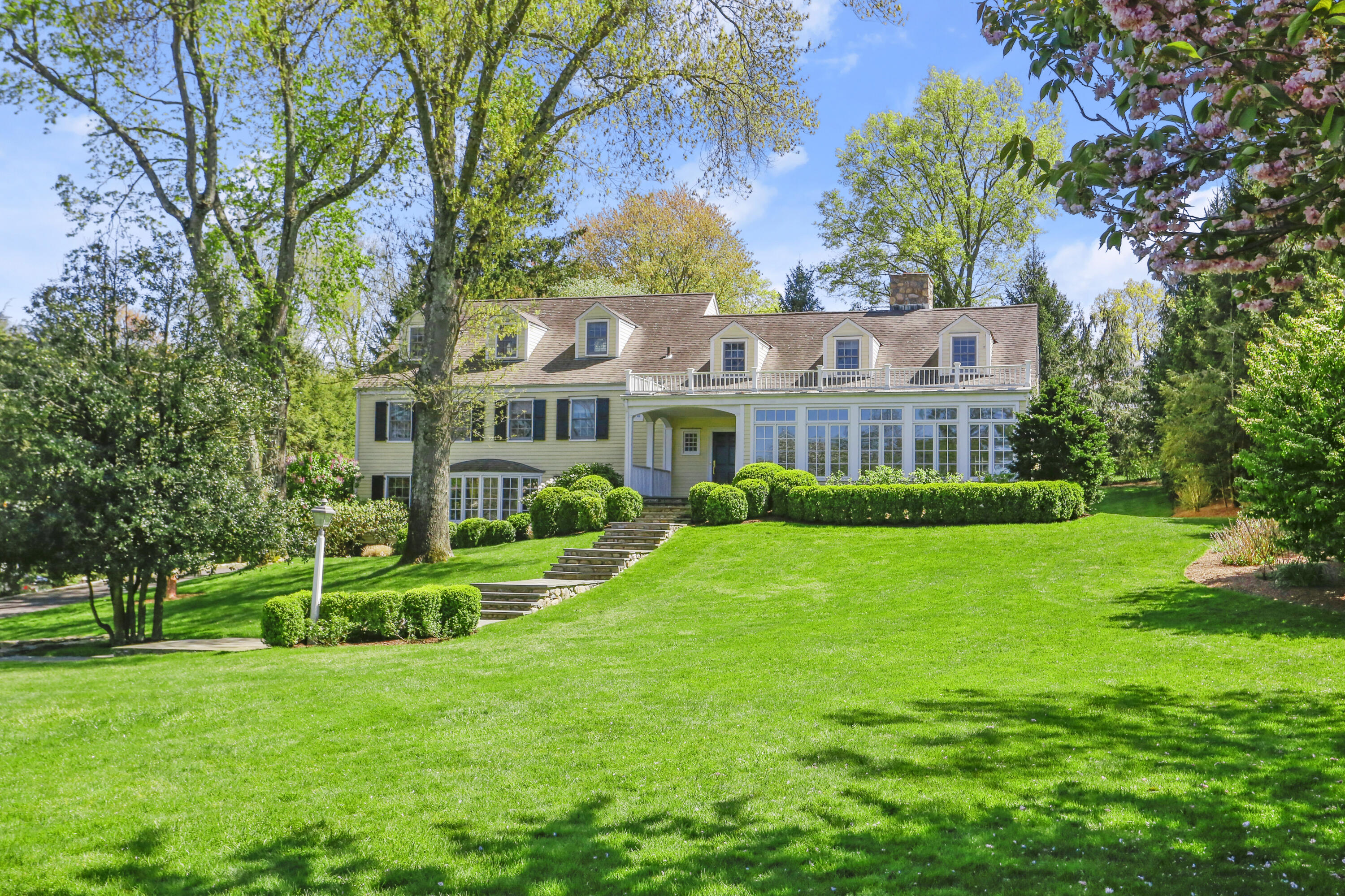 a front view of a house with a garden