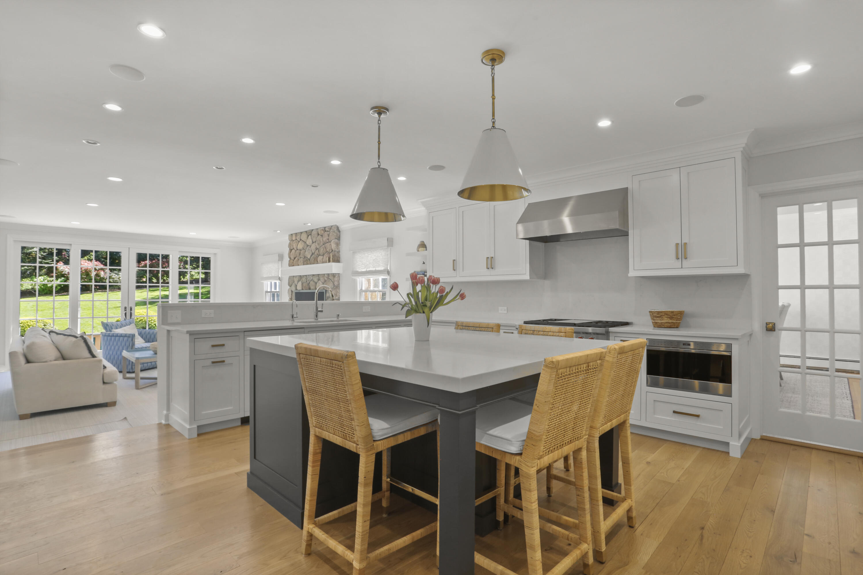 10 Saddle Ridge Road Darien, CT 06820 - Photo 11 of 41 a kitchen with stainless steel appliances granite countertop a stove a sink a kitchen island with chairs and wooden floor
