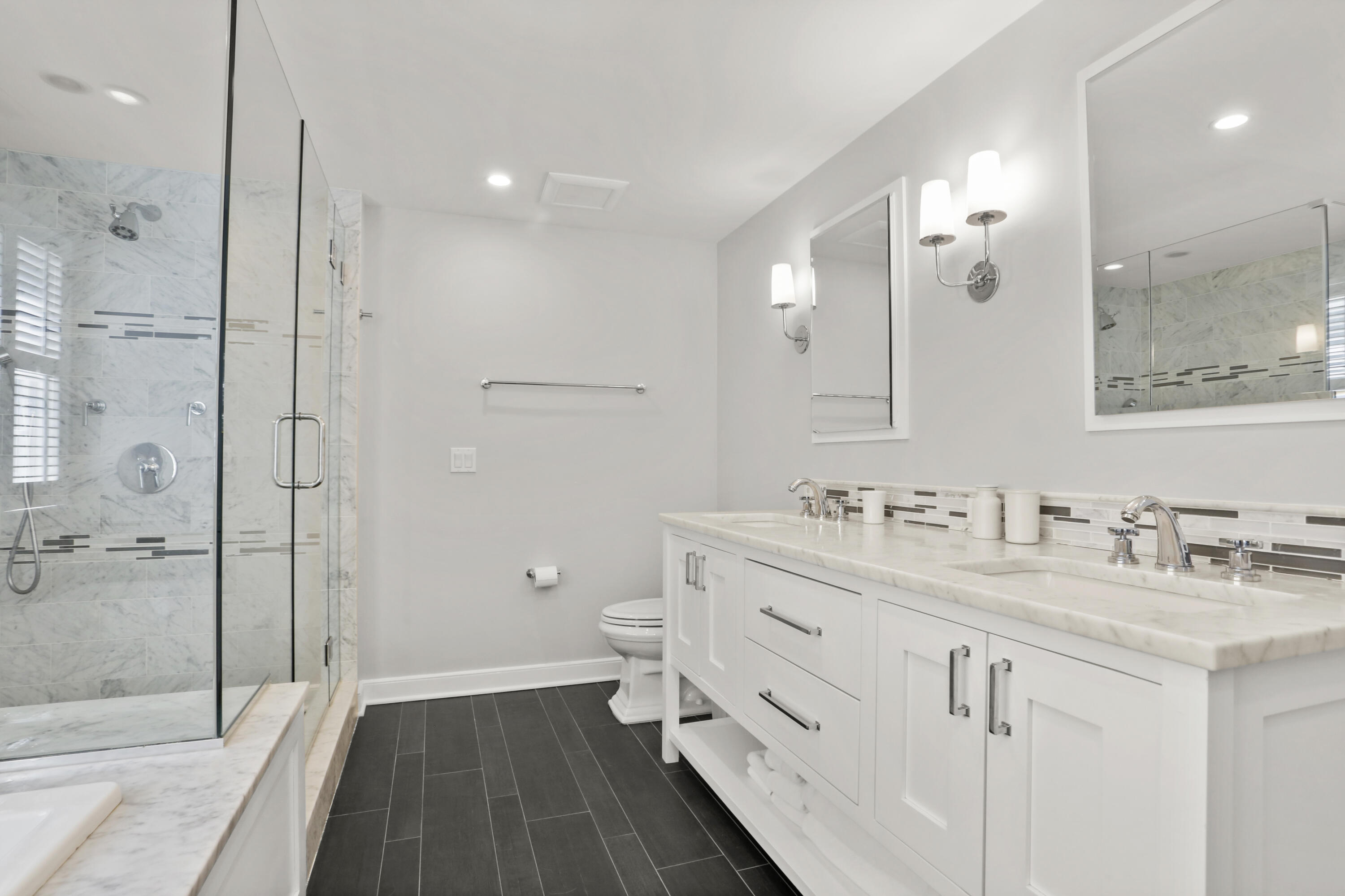 10 Saddle Ridge Road Darien, CT 06820 - Photo 16 of 41 a bathroom with a double vanity sink toilet mirror and windows