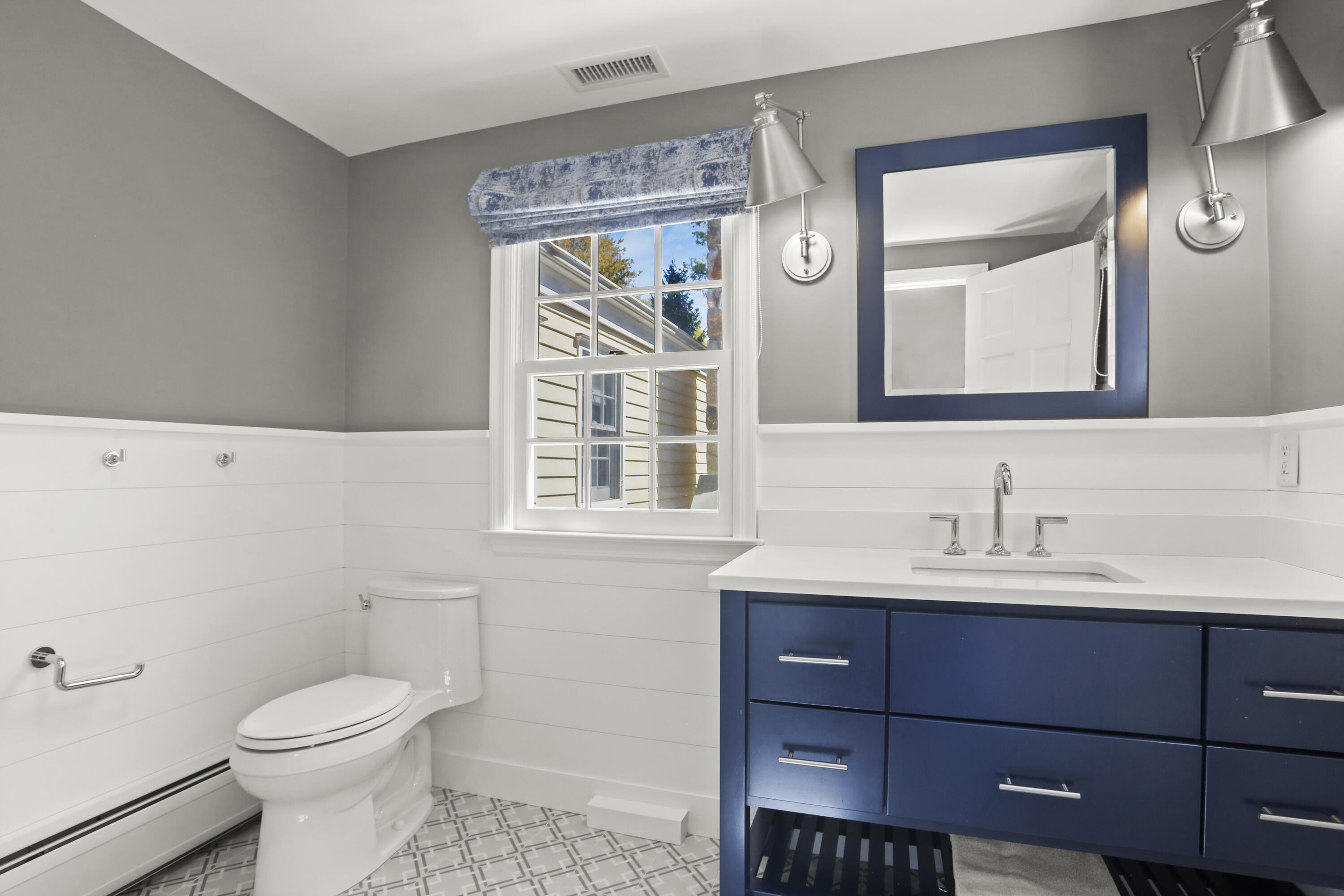 10 Saddle Ridge Road Darien, CT 06820 - Photo 25 of 41 a bathroom with a toilet a sink a vanity and mirror