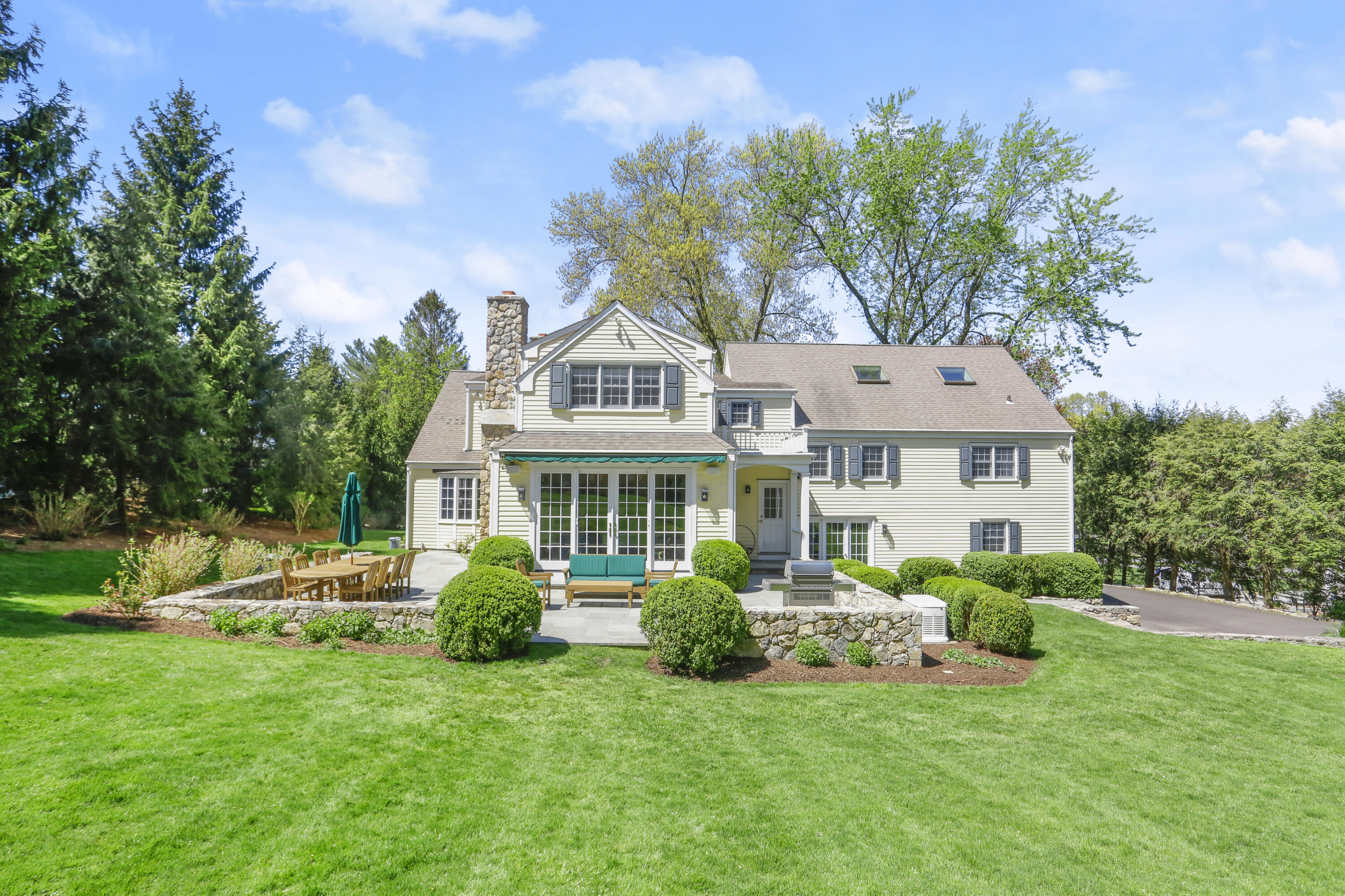 10 Saddle Ridge Road Darien, CT 06820 - Photo 33 of 41 a front view of a house with a garden