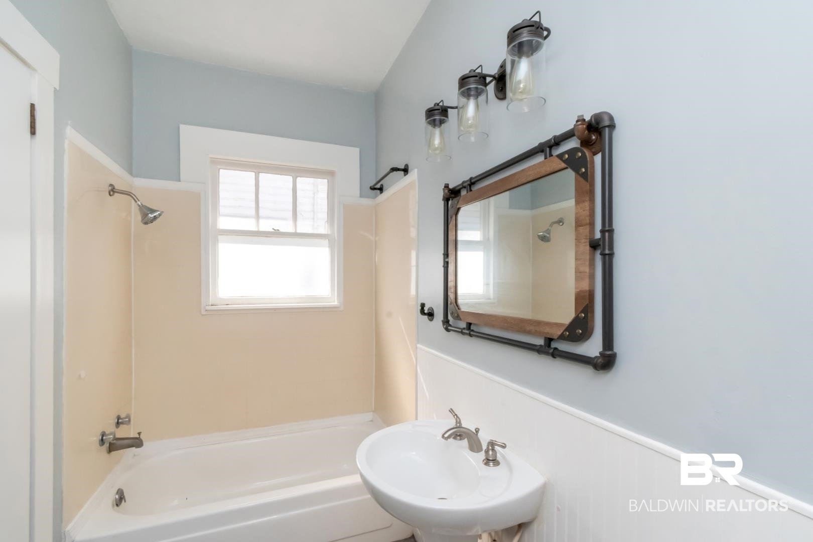 731 Jemison Street Mobile, AL 36606 - Photo 12 of 27 Bathroom with bathtub / shower combination and a wainscoted wall