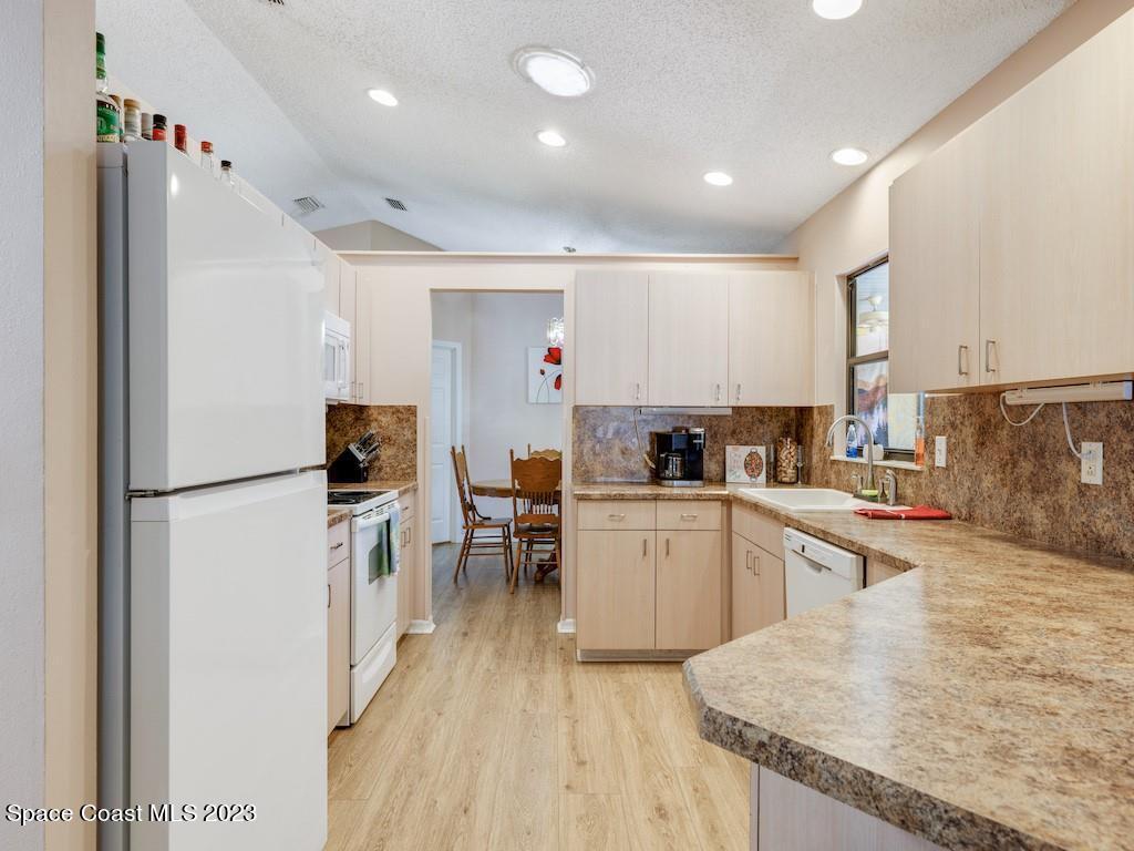 a kitchen with stainless steel appliances granite countertop refrigerator sink and stove