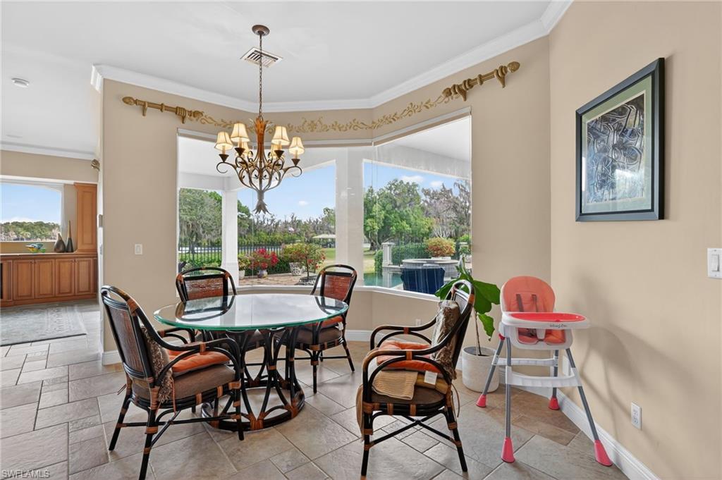 1964 Rialto Way Alva, FL 33920 - Photo 11 of 50 a view of a dining room with furniture a chandelier and large windows