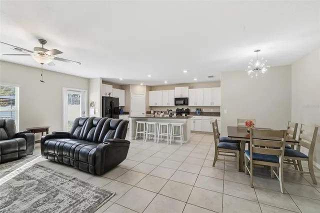 a living room with furniture and kitchen view