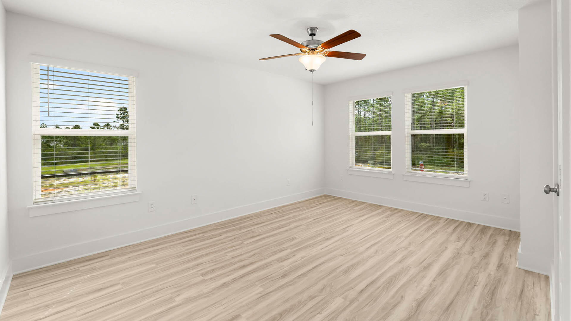 137 Hawk Street Santa Rosa Beach, FL 32459 - Photo 17 of 30 an empty room with wooden floor and windows