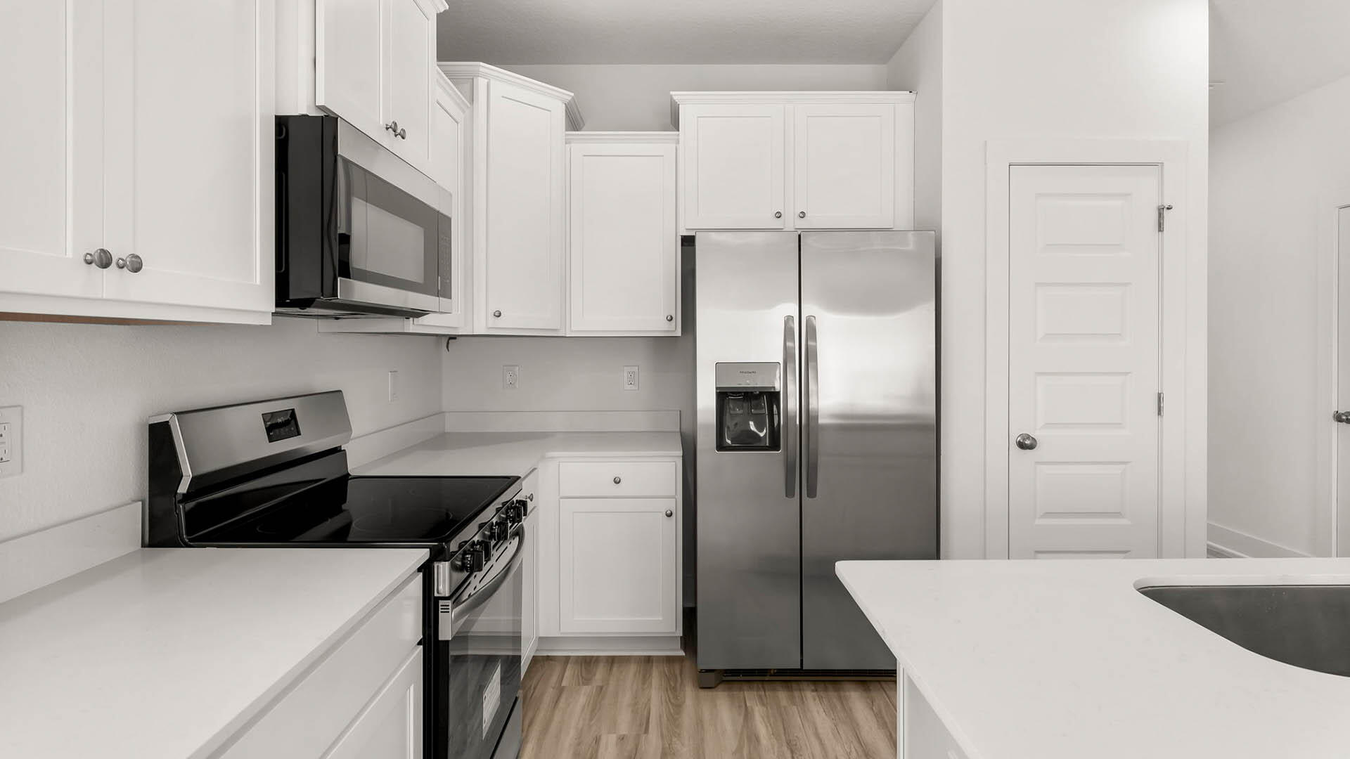 137 Hawk Street Santa Rosa Beach, FL 32459 - Photo 7 of 30 a kitchen with a refrigerator and a stove top oven