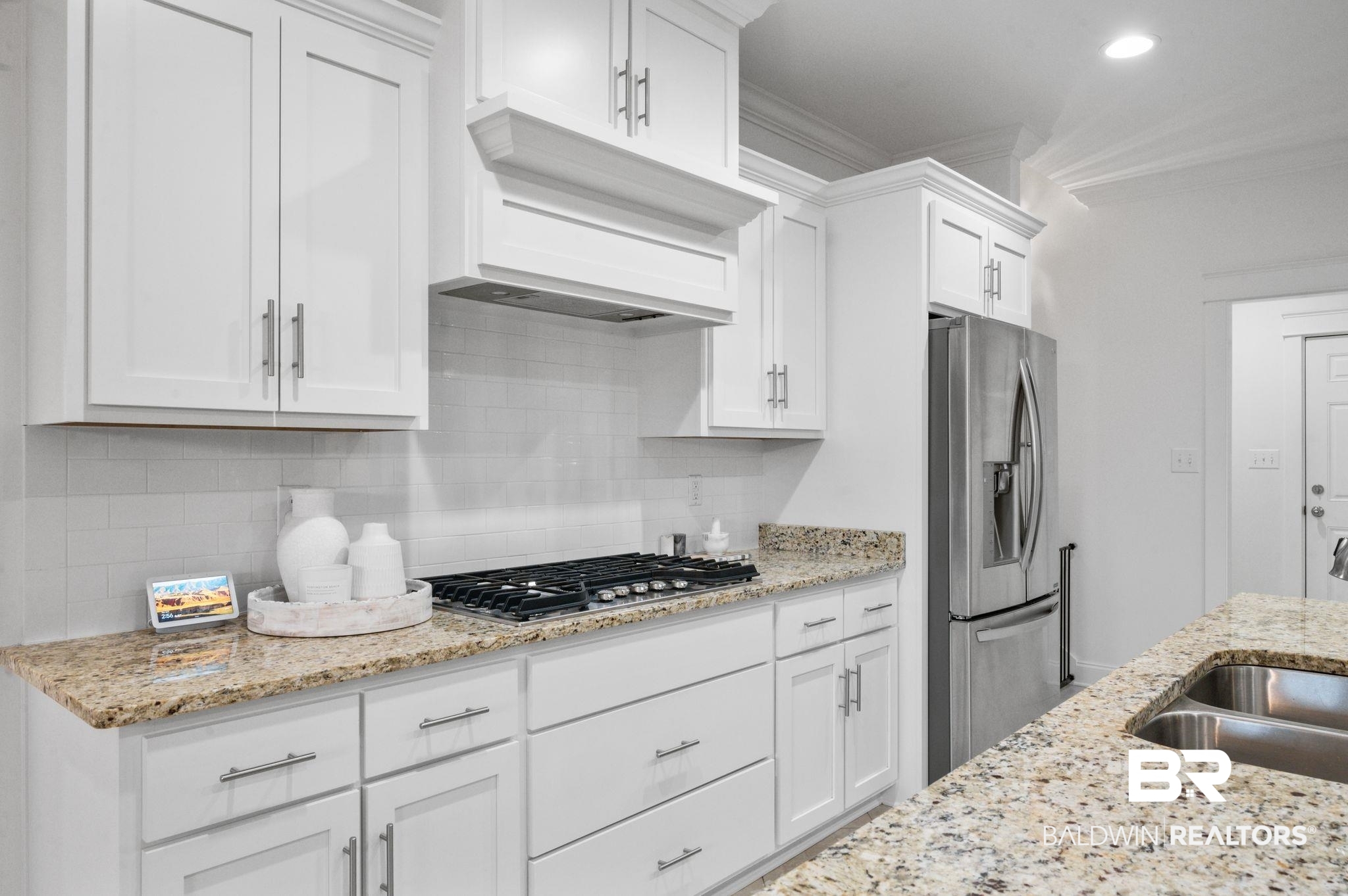 418 Fortune Drive Fairhope, AL 36532 - Photo 13 of 63 Kitchen with white cabinetry, stainless steel appliances, tasteful backsplash, and ornamental molding