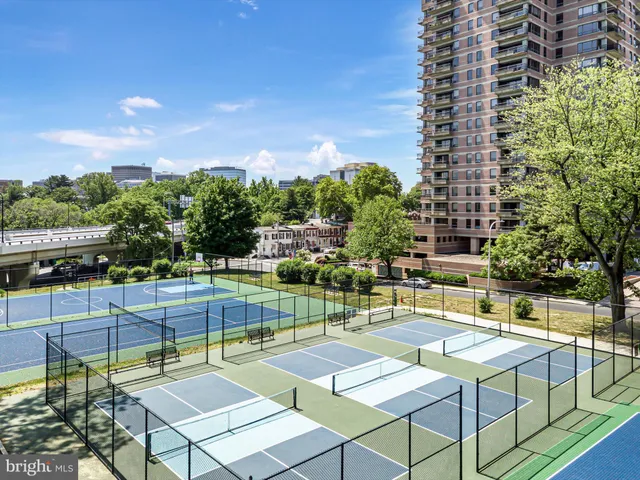 a view of a patio with a table and chairs and potted plants
