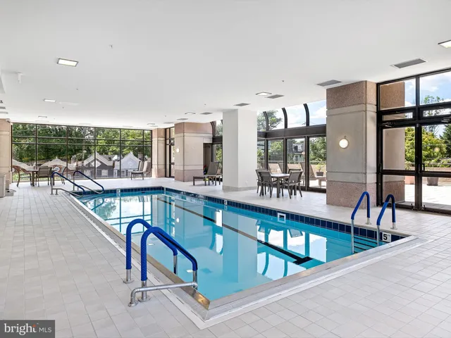a view of a swimming pool with outdoor seating