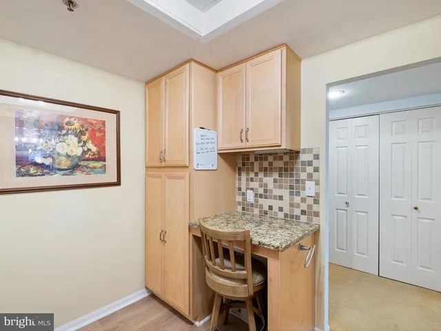 a kitchen with stainless steel appliances cabinets and wooden floor