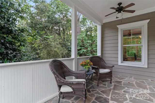 a view of a porch with furniture and a yard