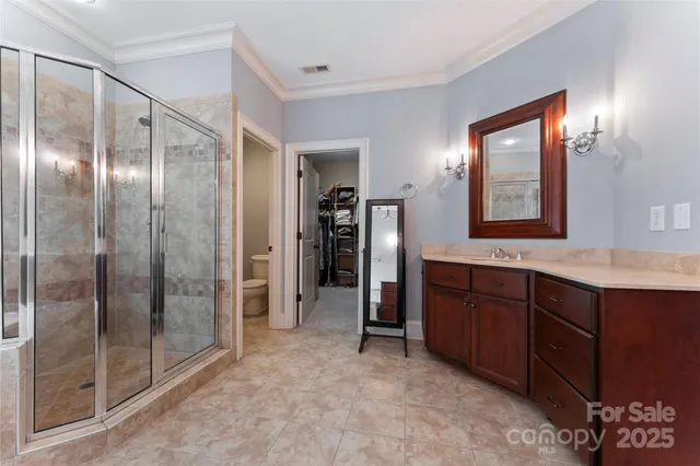 a bathroom with a shower sink and mirror