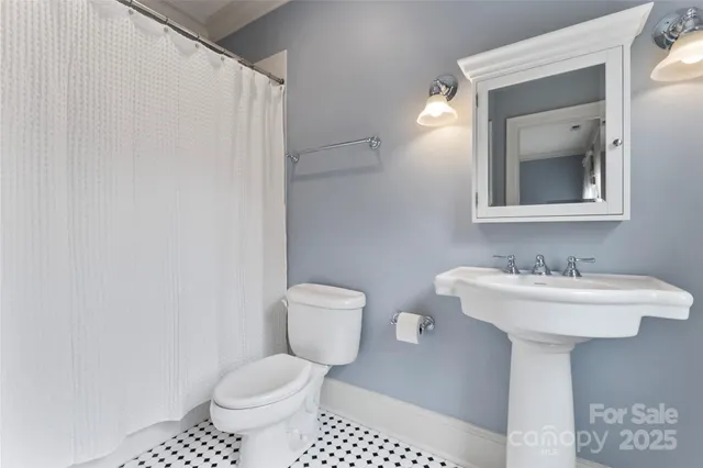 a bathroom with a sink toilet and mirror