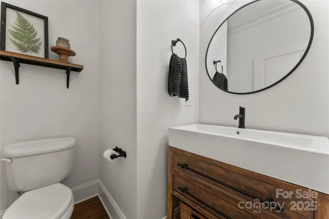 a bathroom with a sink mirror and toilet