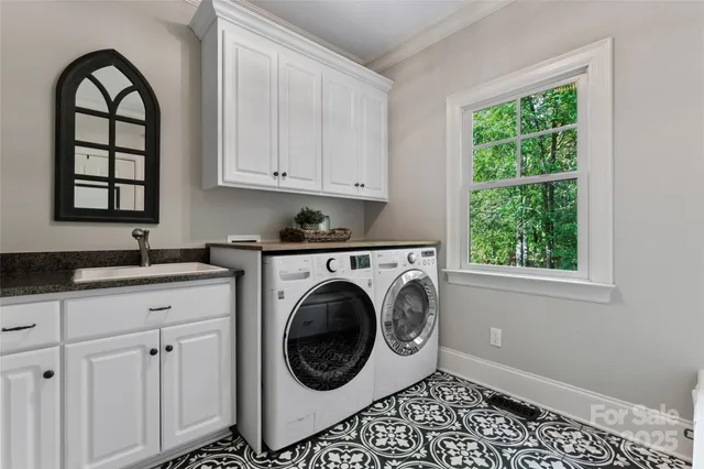 a kitchen with a white cabinets and a window