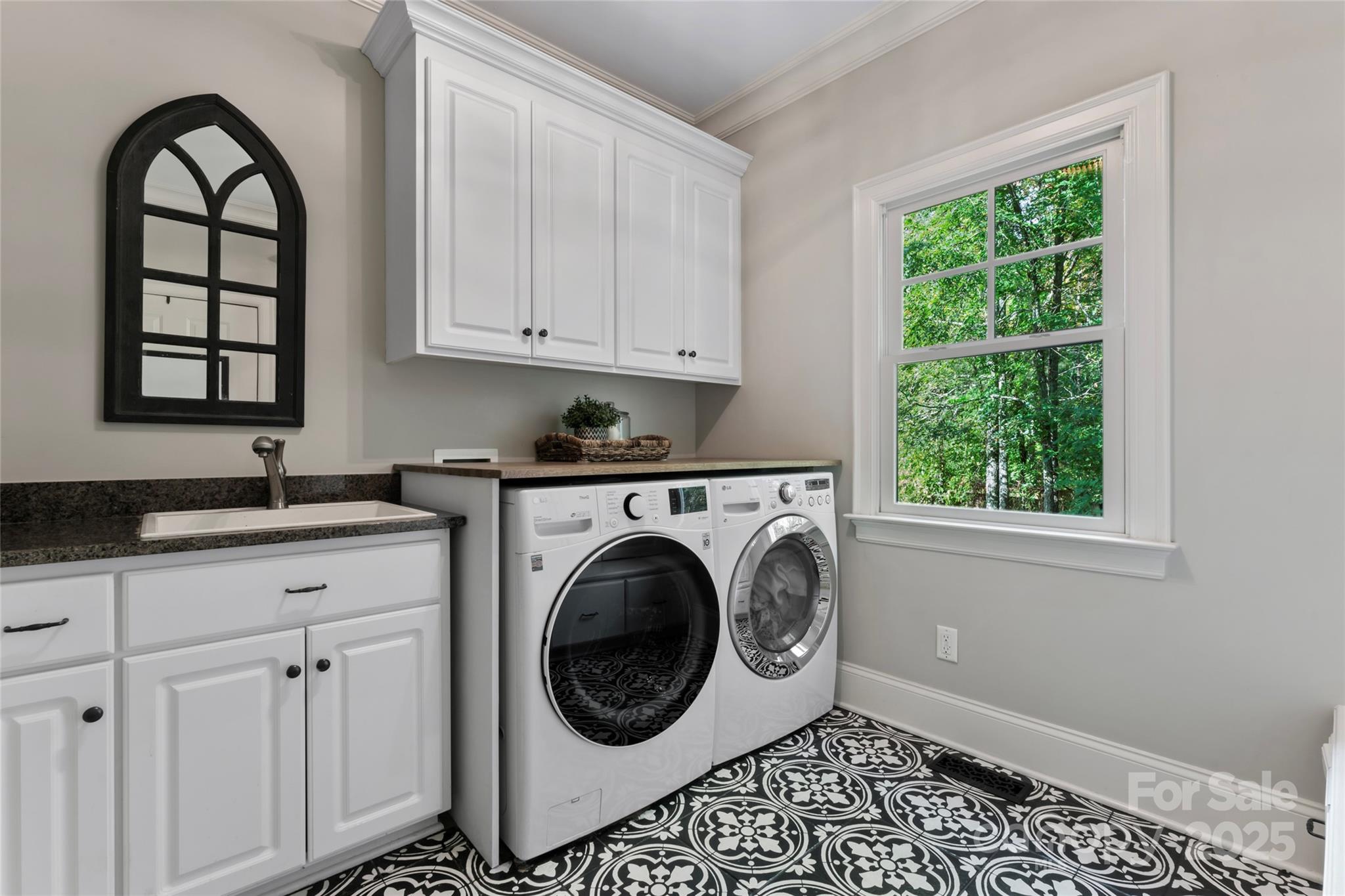 235 Grey Road Davidson, NC 28036 - Photo 24 of 37 a kitchen with a white cabinets and a window