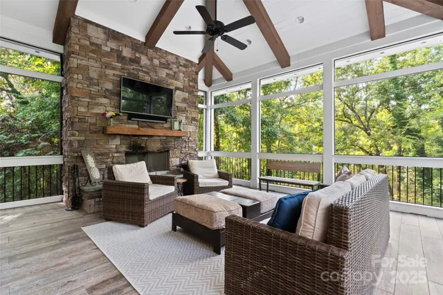a living room with fireplace furniture and a flat screen tv