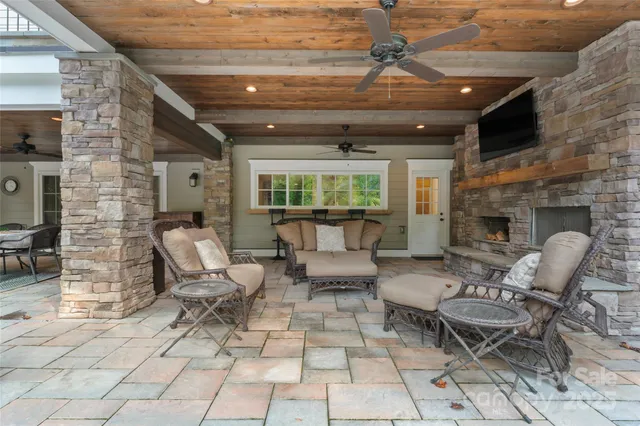 a outdoor space with patio furniture and a fireplace