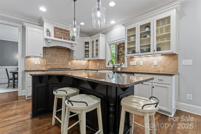 a kitchen with a sink cabinets and window