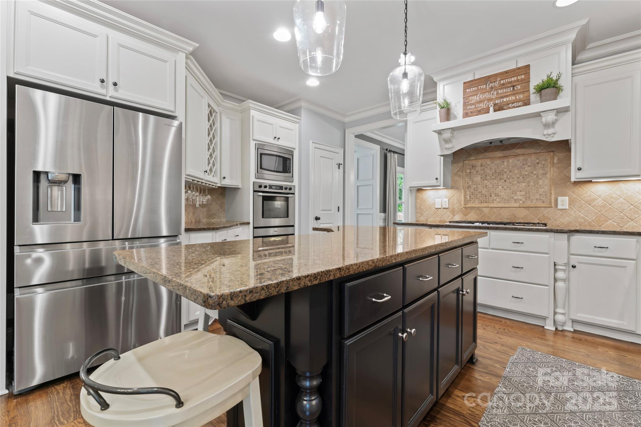 235 Grey Road Davidson, NC 28036 - Photo 8 of 37 a kitchen with stainless steel appliances a sink cabinets and wooden floor