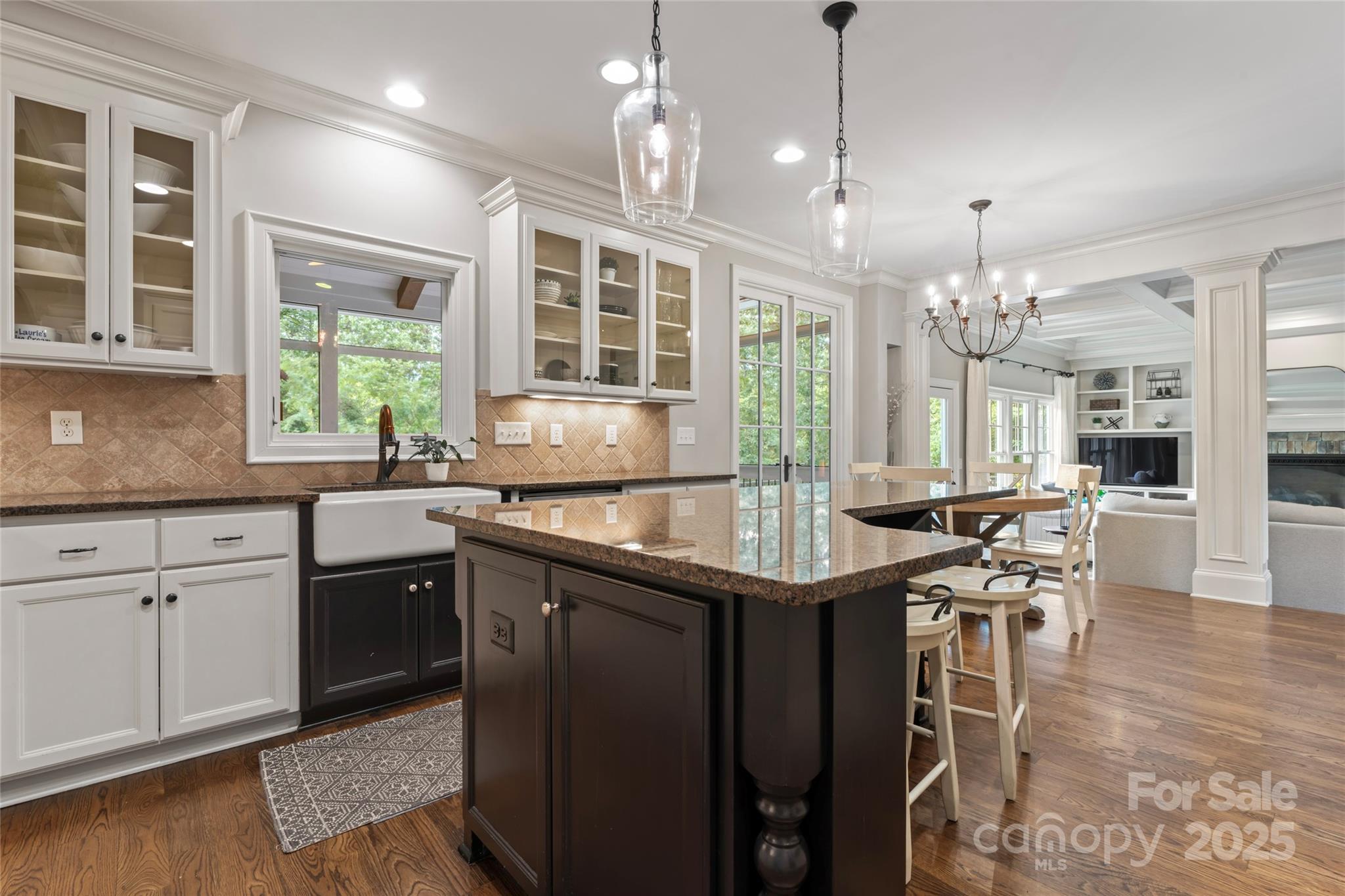 235 Grey Road Davidson, NC 28036 - Photo 9 of 37 a kitchen with stainless steel appliances granite countertop a stove top oven a sink dishwasher a dining table and chairs with wooden floor