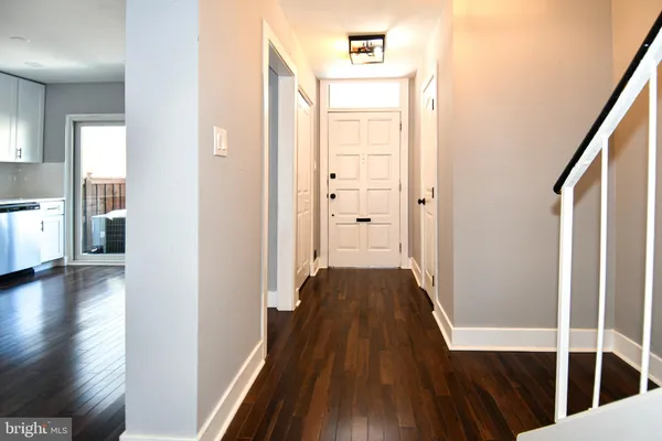 a kitchen with kitchen island a stove a sink a microwave and wooden floor