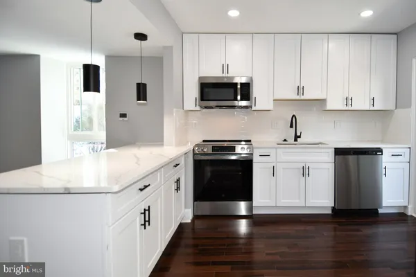 a stove top oven sitting inside of a kitchen