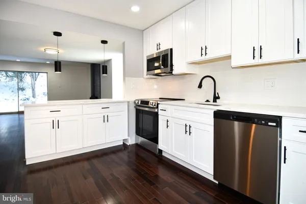 a kitchen with a sink and a stove top oven