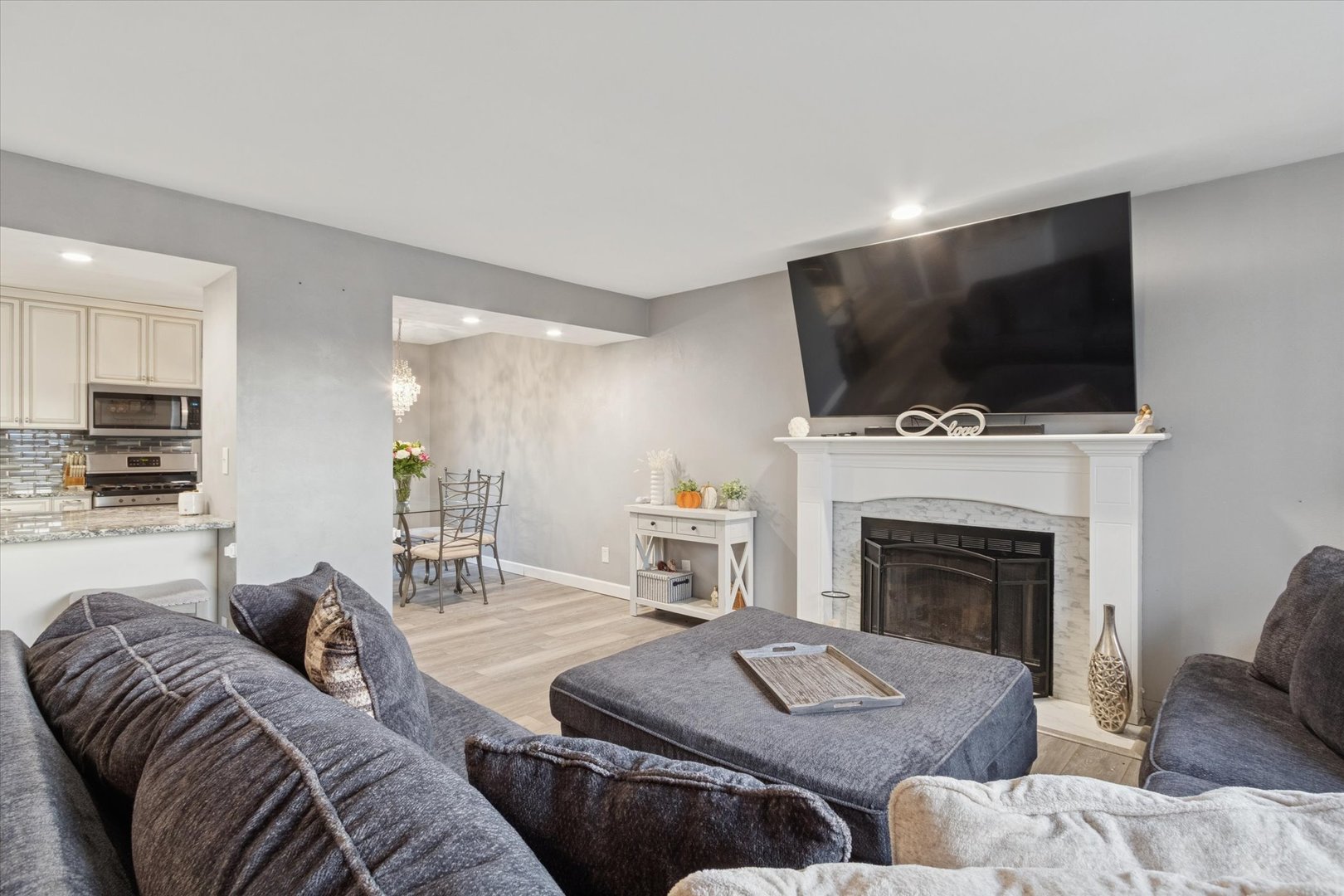 549 Bayfield Road Rockton, IL 61073 - Photo 7 of 42 a living room with furniture a flat screen tv and a fireplace
