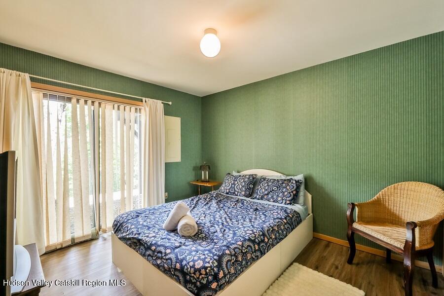 111 Brainard Ridge Road, Unit 11B Windham, NY 12496 - Photo 12 of 18 a bedroom with a bed and chair