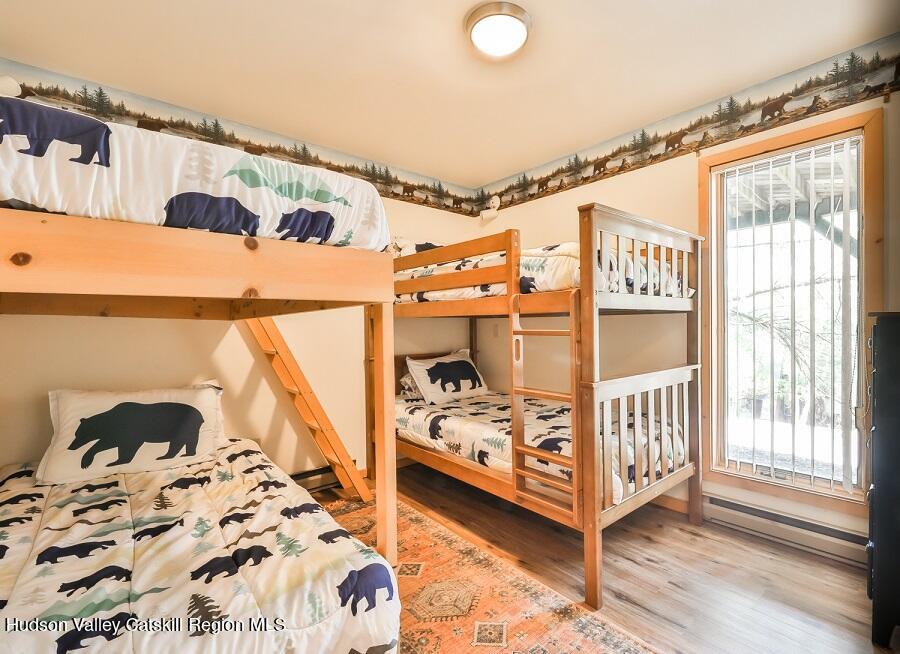 111 Brainard Ridge Road, Unit 11B Windham, NY 12496 - Photo 14 of 18 a bedroom with a bed and wooden floor