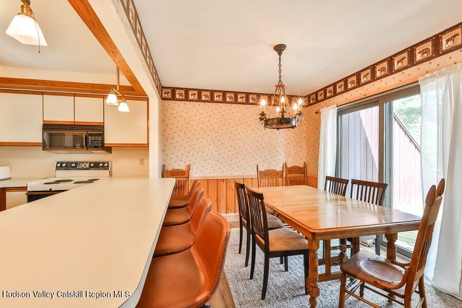 111 Brainard Ridge Road, Unit 11B Windham, NY 12496 - Photo 5 of 18 a dining room with furniture and window