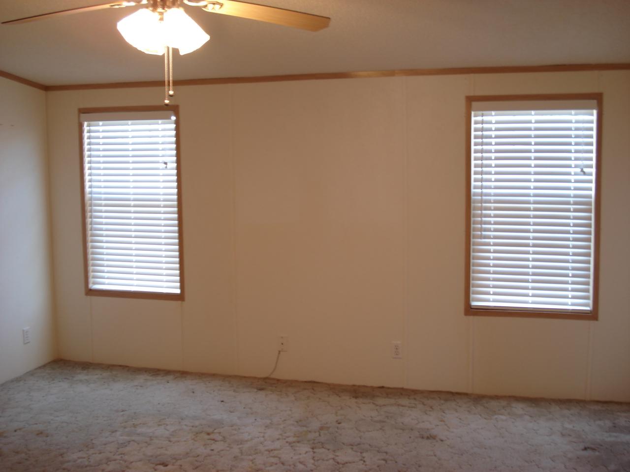2015 Lick Ridge Road Northeast Check, VA 24072 - Photo 7 of 10 an empty room with a window and a chandelier fan