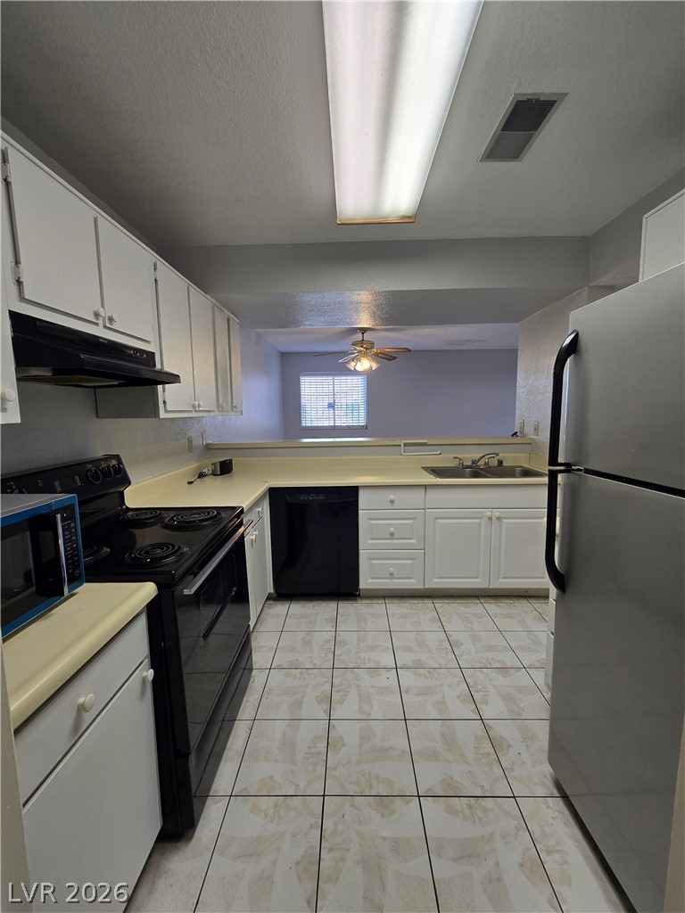 6750 Del Rey Avenue, Unit 133 Las Vegas, NV 89146 - Photo 12 of 34 Functional kitchen with ample cabinetry and a practical layout.