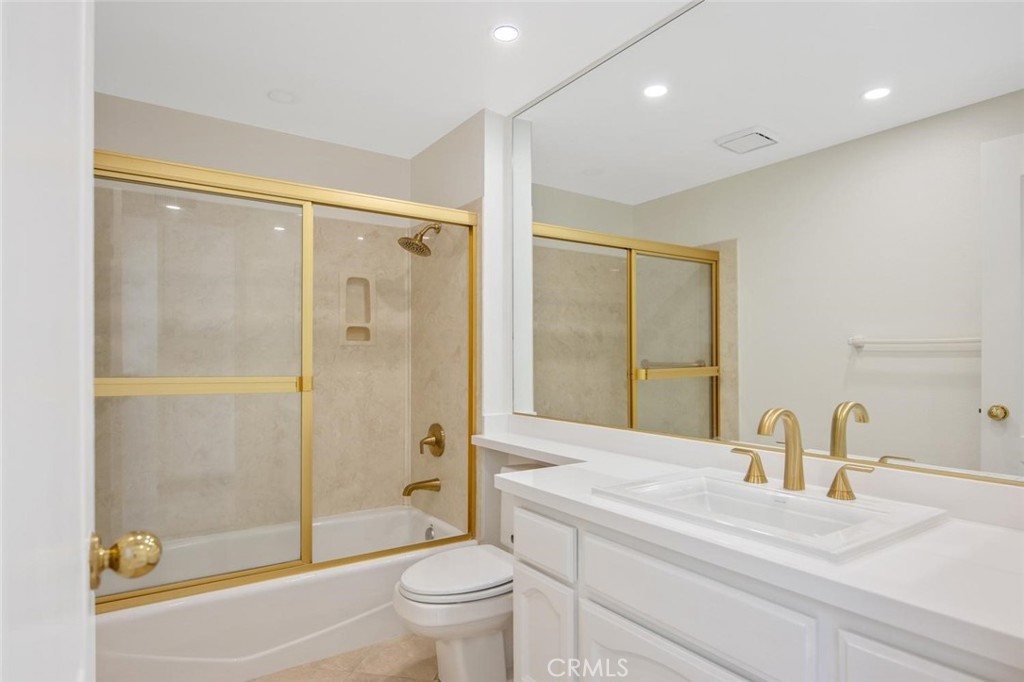 5974 Ruthwood Drive Calabasas, CA 91302 - Photo 18 of 30 a bathroom with a granite countertop sink a toilet and shower