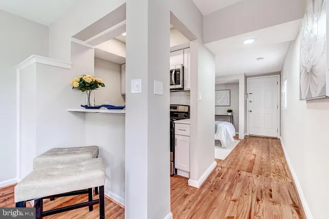 a view of kitchen with furniture and wooden floor