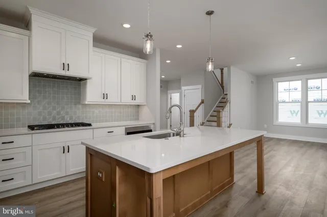 a kitchen with a sink cabinets and window