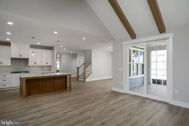 a large kitchen with a sink and a stove top oven