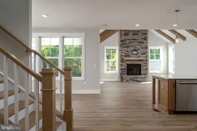 a view of empty room with wooden floor and fireplace