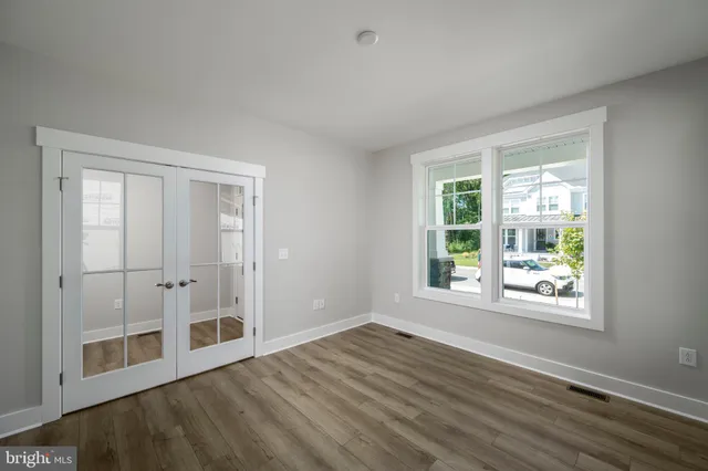 a view of wooden floor and windows in a room