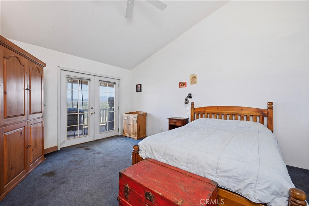 16965 Spruce Grove Road Hidden Valley Lake, CA 95467 - Photo 13 of 34 a bedroom with furniture and white walls