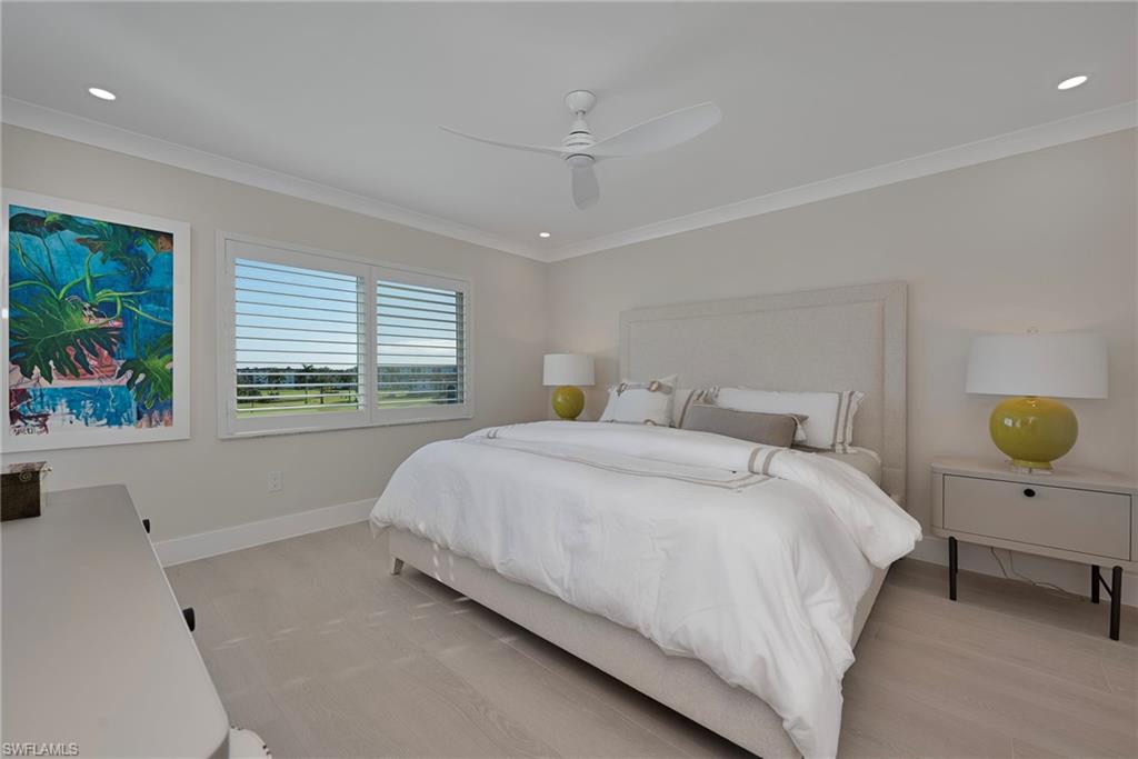 57 High Point Circle West, Unit 405 Naples, FL 34103 - Photo 11 of 15 a bedroom with a bed and a window
